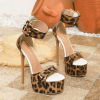 Pair of leopard peep toe platform heels in three-quarter product view
