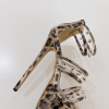 Clear cage straps and studded details on leopard platform heel