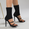 Black open toe stretch sock boot heels worn from front