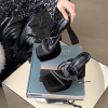 Black strappy platform heels styled on stacked books