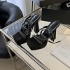 Pair of black rhinestone platform heels viewed from above